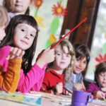 Preschoolers in a classroom learning together, reflecting values of empathy and respect in local private preschools.