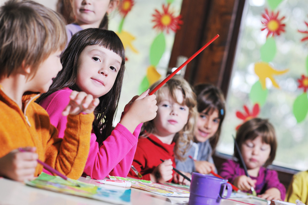 Preschoolers in a classroom learning together, reflecting values of empathy and respect in local private preschools.
