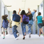 Elementary school children running happily at a private elementary school